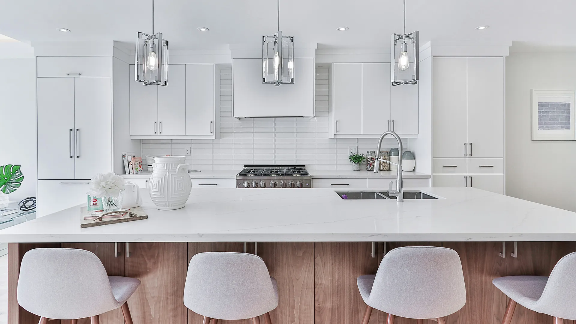 Modern minimalist white kitchen interior with a marble island countertop